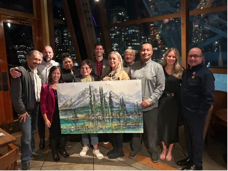 Chief Allan Adam and the ESS team stand with ACFN members in Vancouver, posing with a painted gift presented by ESS North America & East Coast Catering President Adam Shea.
