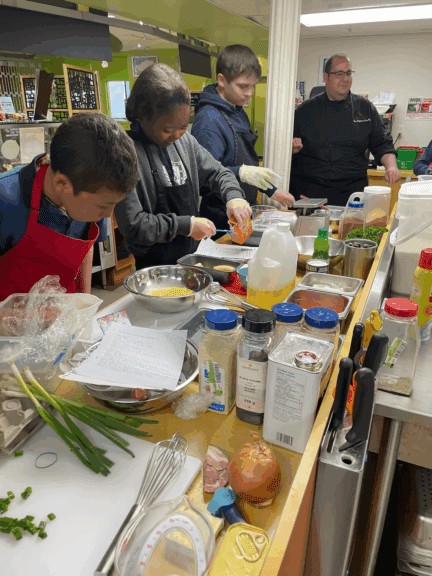 A chef at College do Montreal cooking with students.